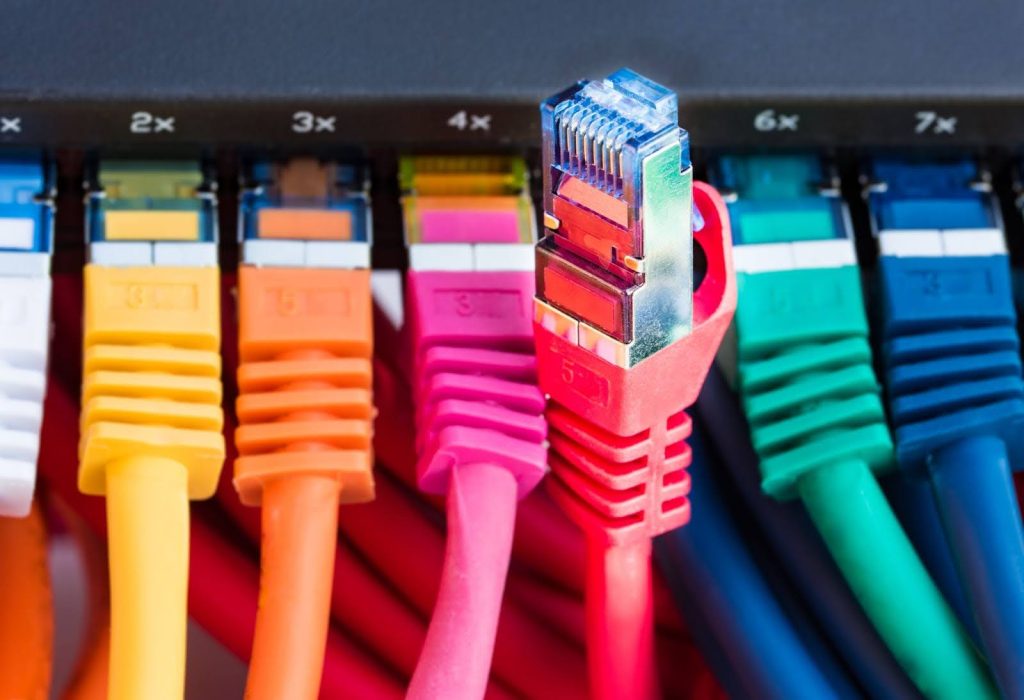 Colorful Ethernet network cables plugged into a black network switch