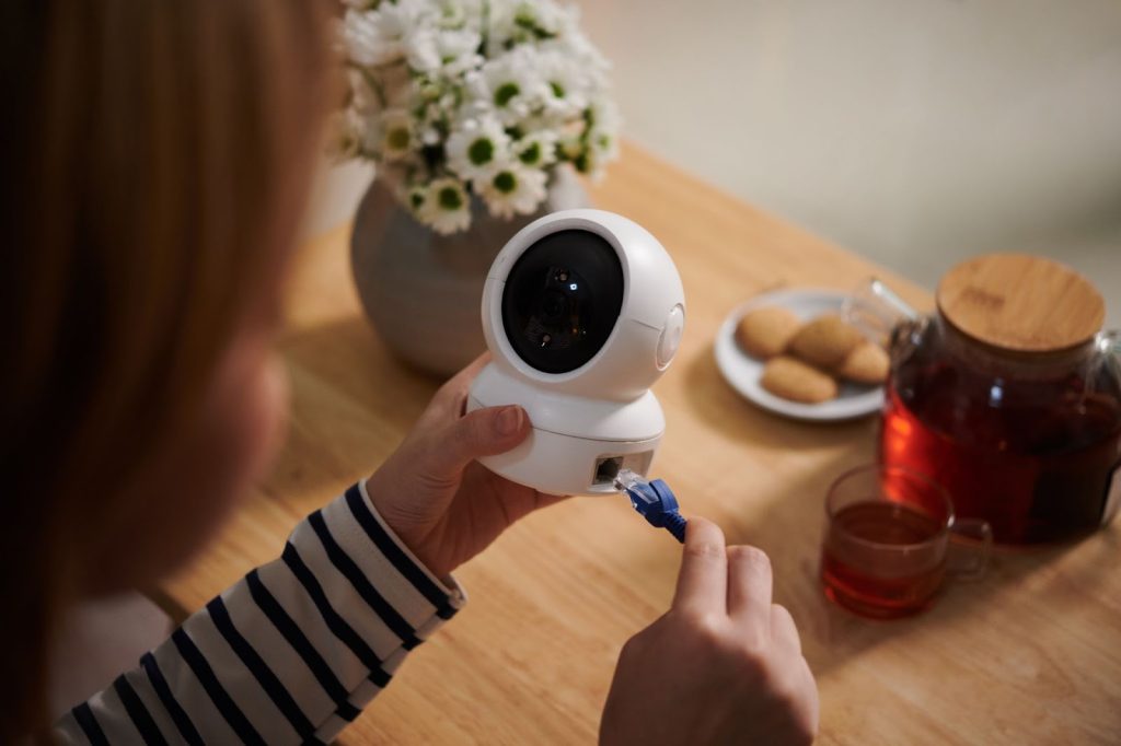 Girl connecting wire to CCTV
