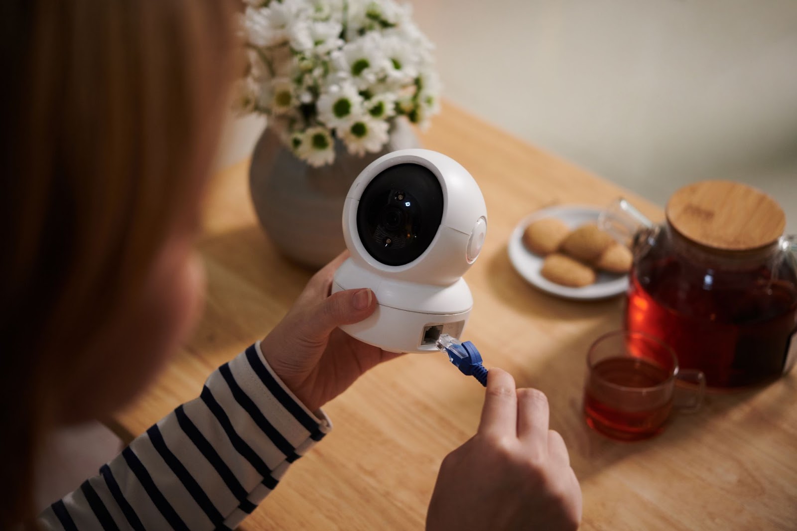 Girl connecting wire to CCTV